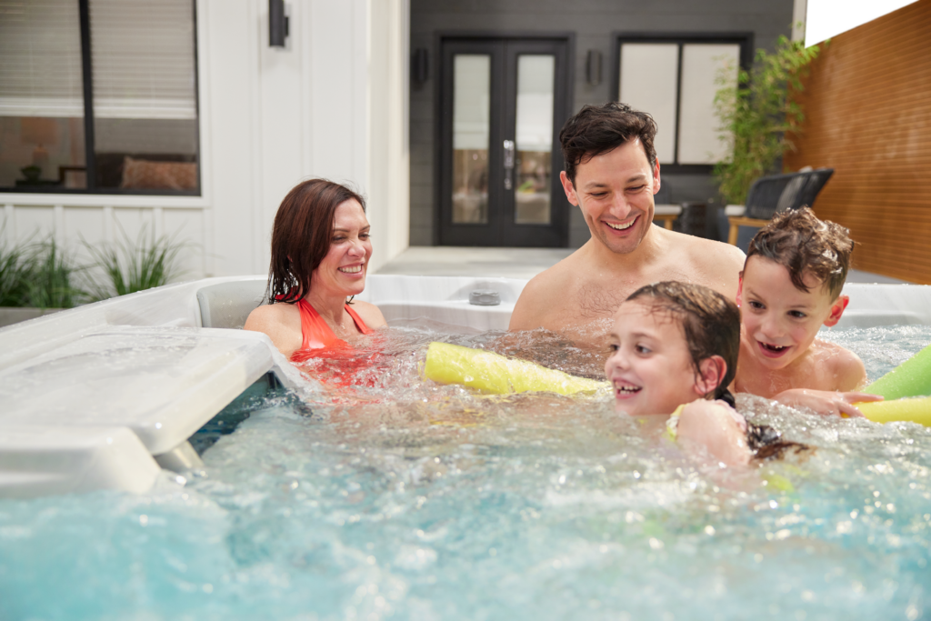 Family having fun in a Sundance Spa 680 Edison