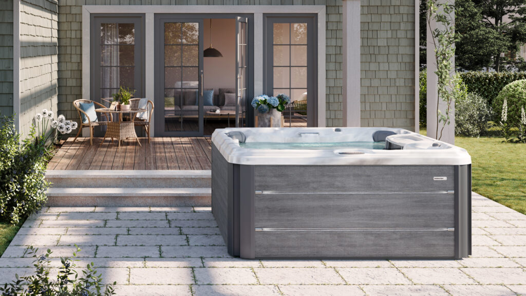 Hot tub showcased infront of patio doors on a nicely displayed garden