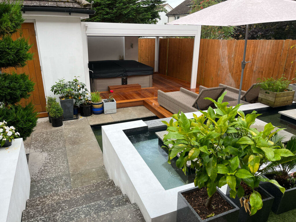 Image showing hot tub in garden with water feature and pergola
