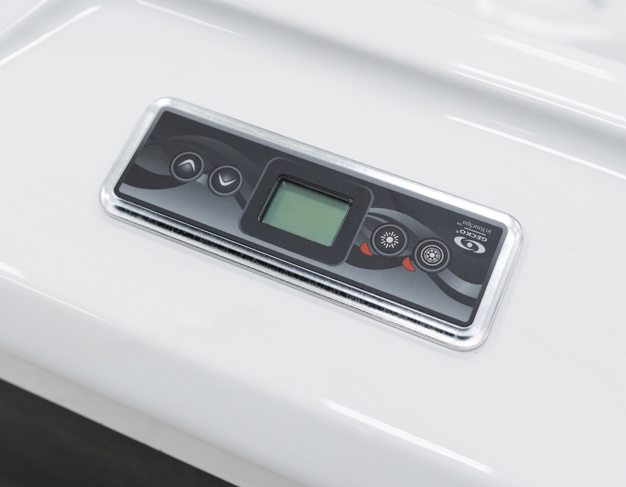 Close-up of a sleek Gecko control panel on a white acrylic hot tub shell.