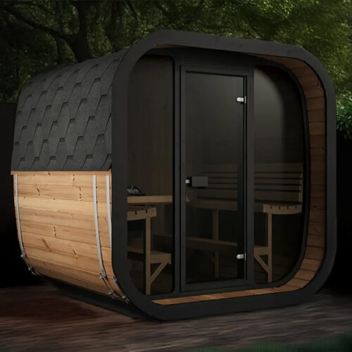 Modern outdoor sauna with a curved, black shingled roof and wooden sides. It features a glass door and benches inside, surrounded by lush greenery.
